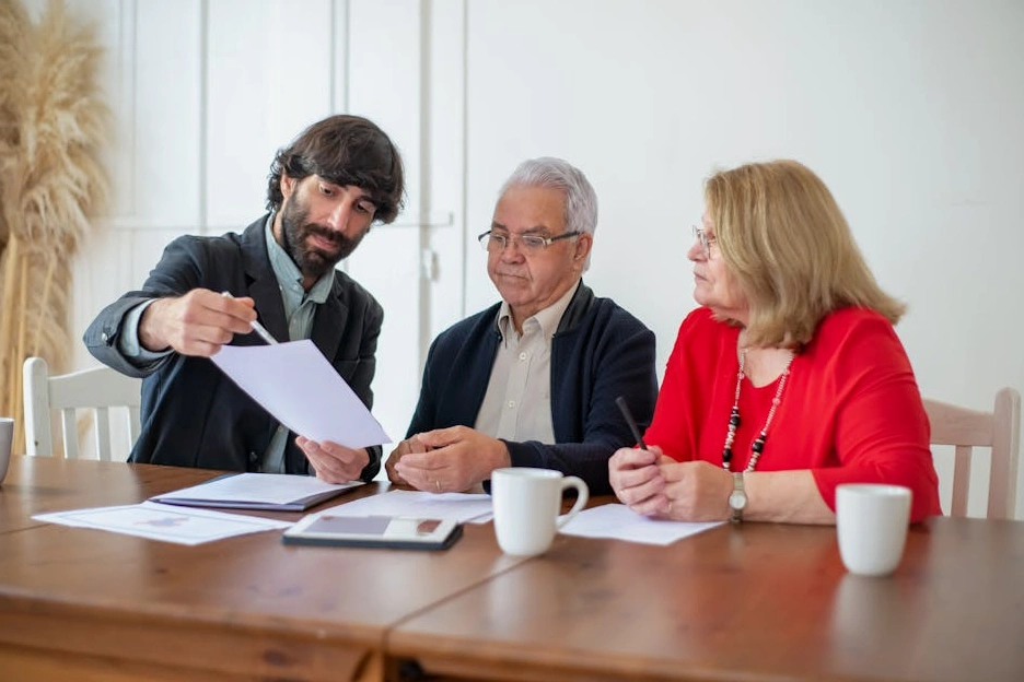 Financial advisor discussing charts with a client in a modern office.